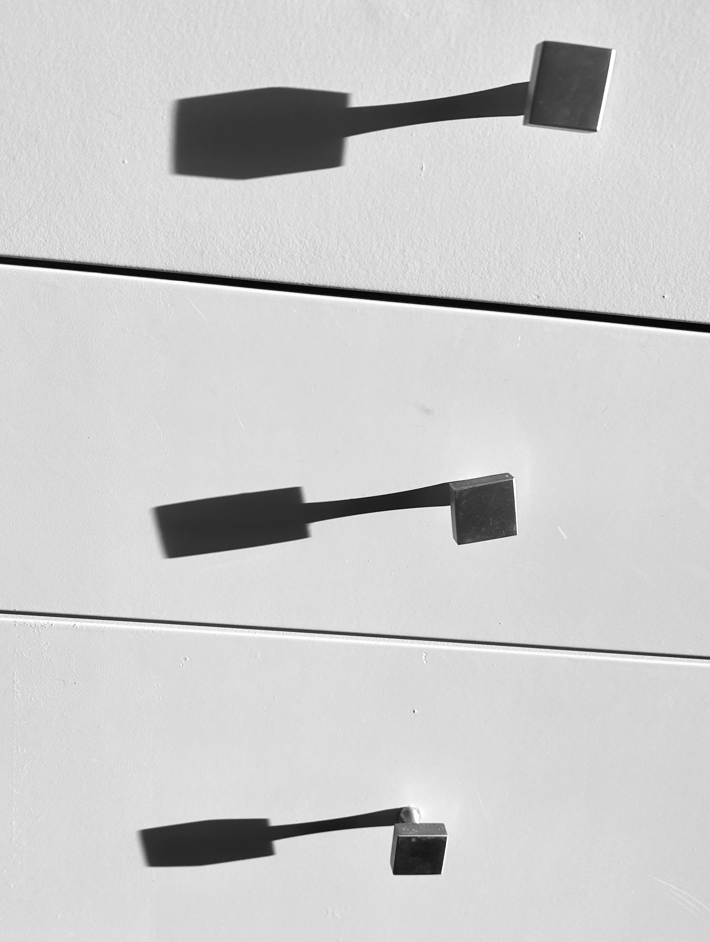  By the way, you can also experiment with indoor shadows cast by the sun through a window or glass door, as in this snap of three drawer knobs. 