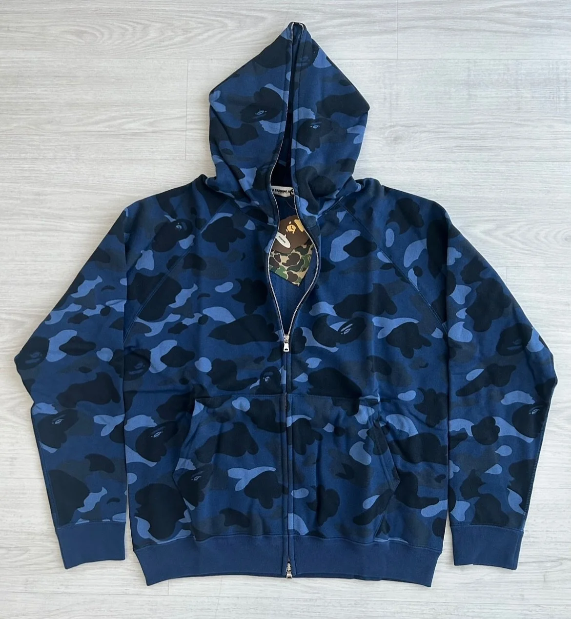 The Favorite Shop collection was part of a collaboration that Nigo released showcasing special pieces often meant to reflect his personal favorites in streetwear, pop culture and music. 

The 1st and 2nd generation blue camo fullzip hoodies were part