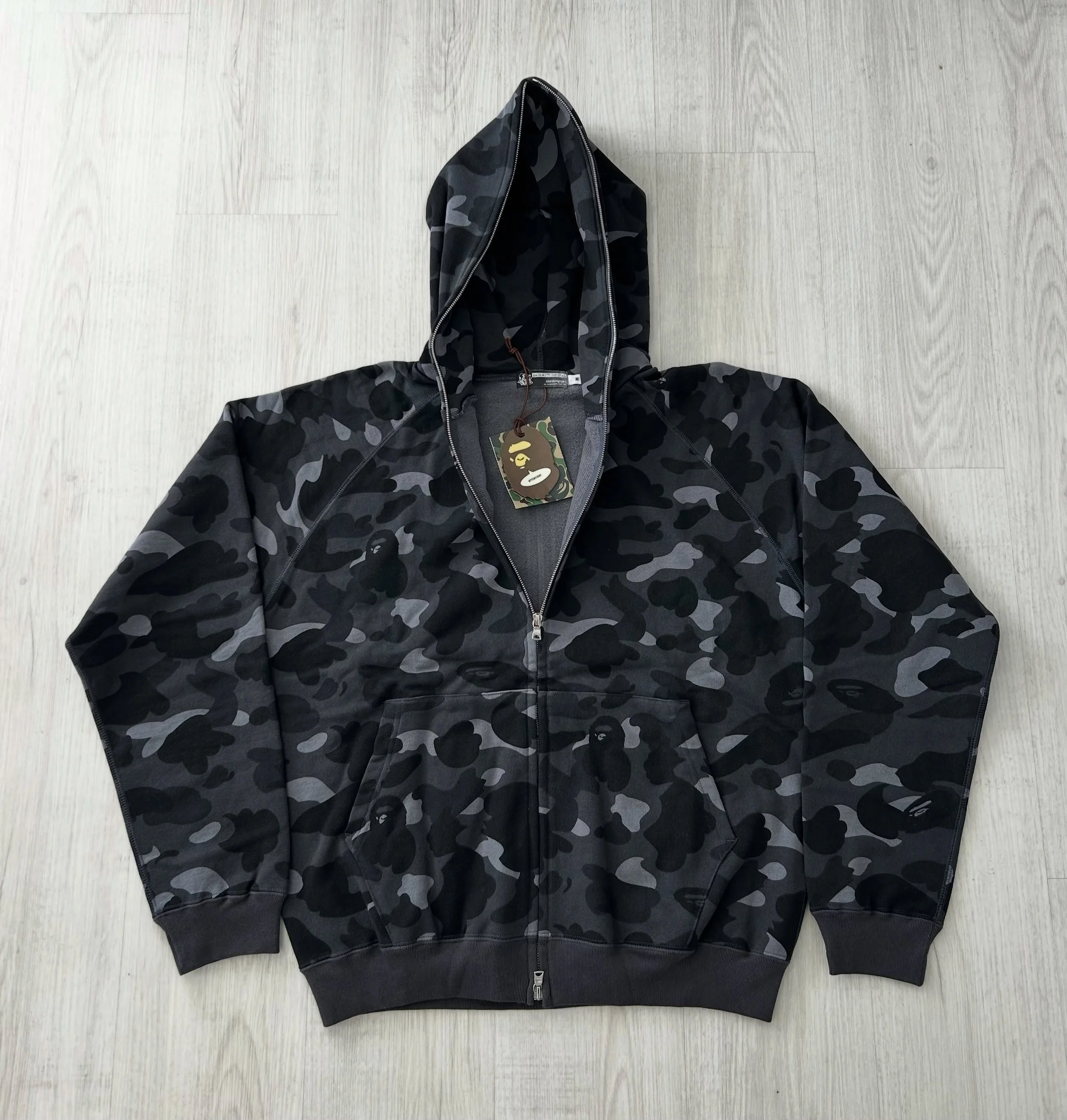 Displayed is an original brand new 2005 A Bathing Ape 1st black camo fullzip hoodie &spades;️ 

The black/grey based camo variants are rarer than the classic yellow and green 1st camo colorways, which makes authentic vintage examples highly sought af