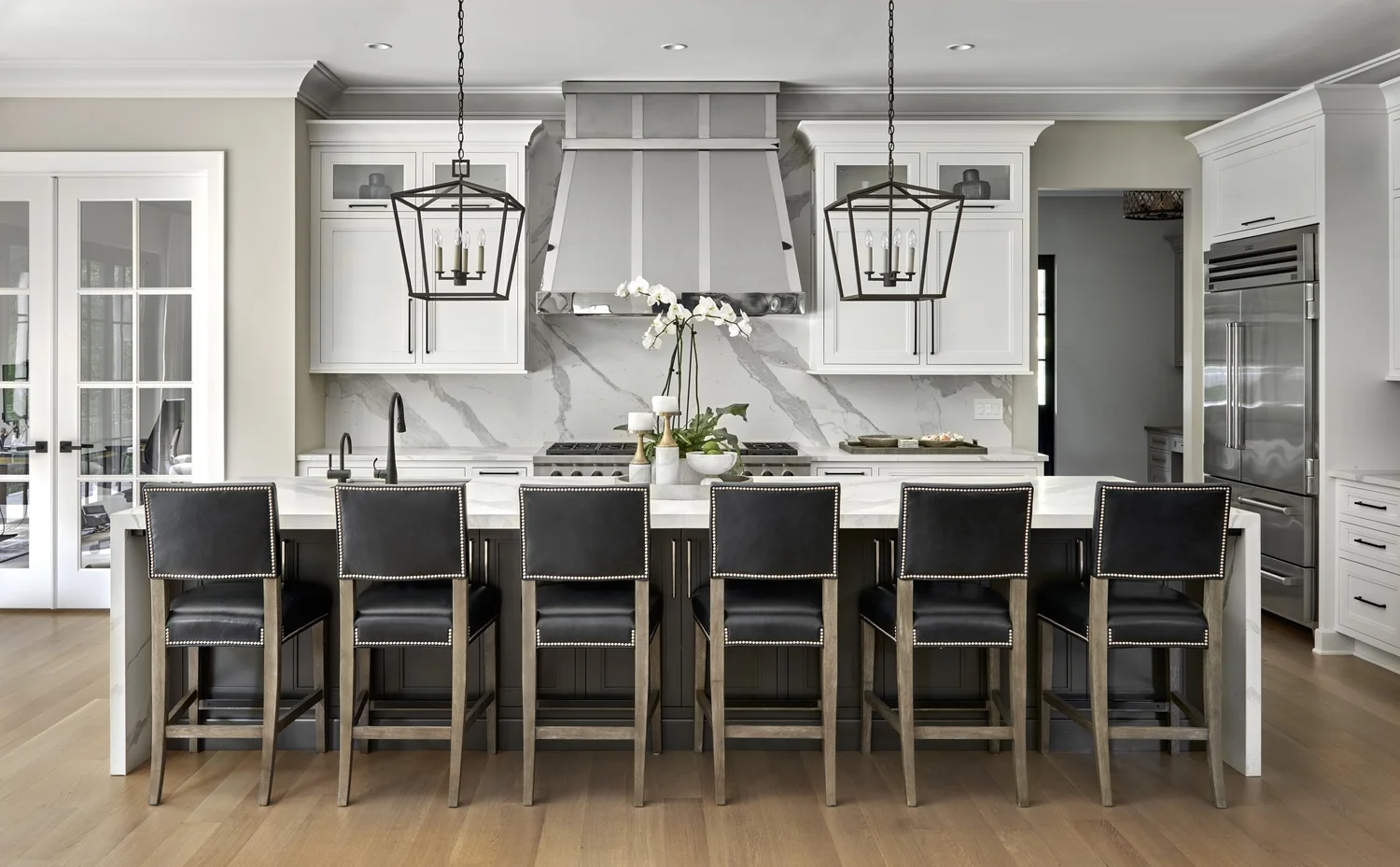 Kitchen with marble counters and custom cabinetry