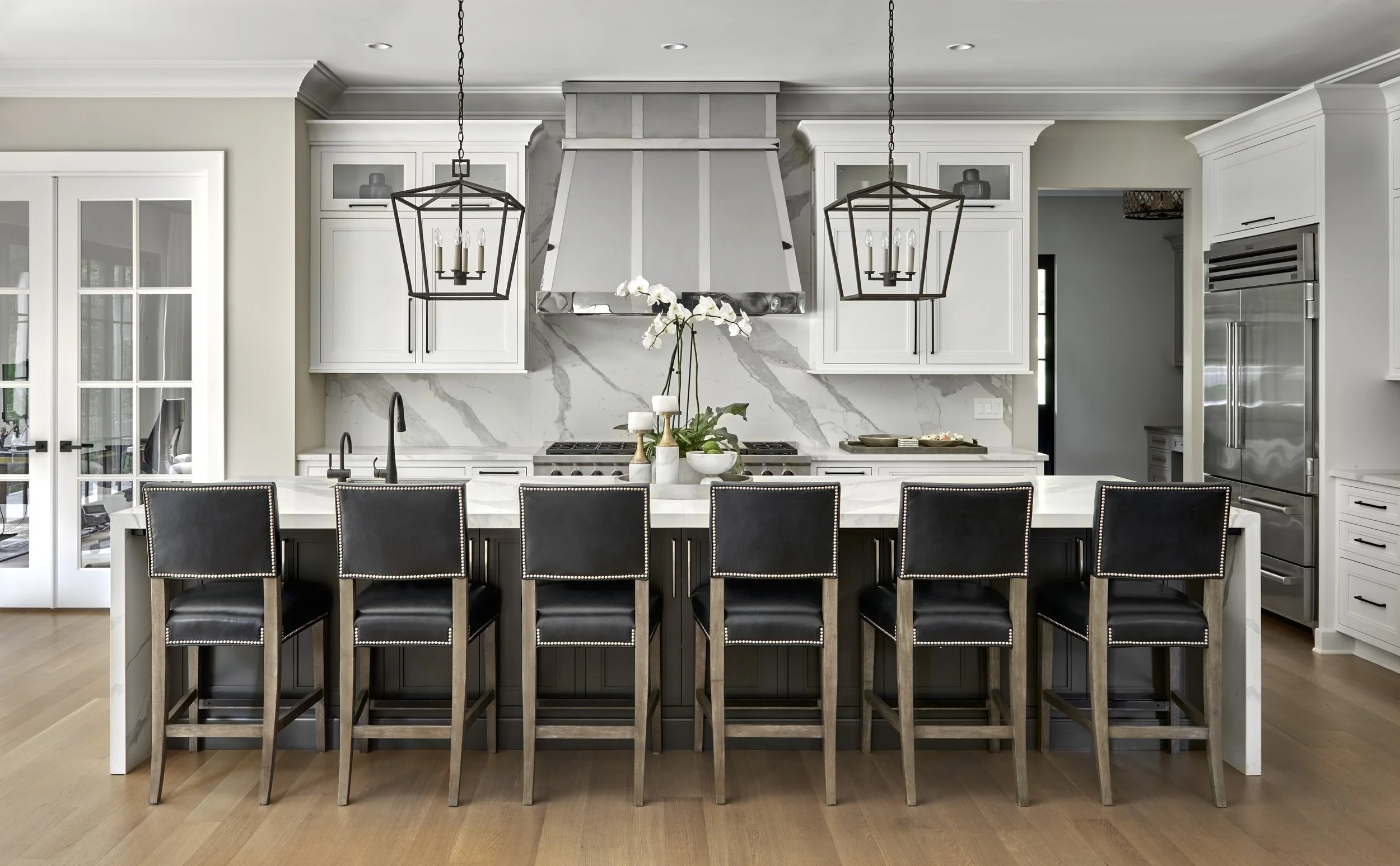 Kitchen with marble counters and custom cabinetry