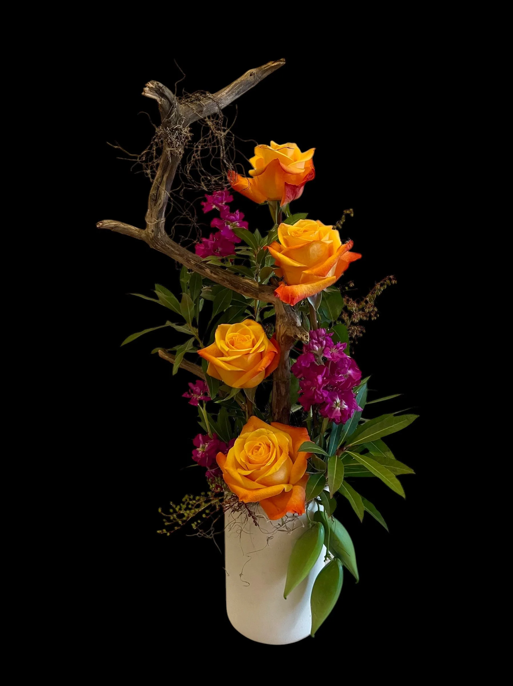 Tall and Narrow arrangement with free spirit roses and purple with driftwood accent stock