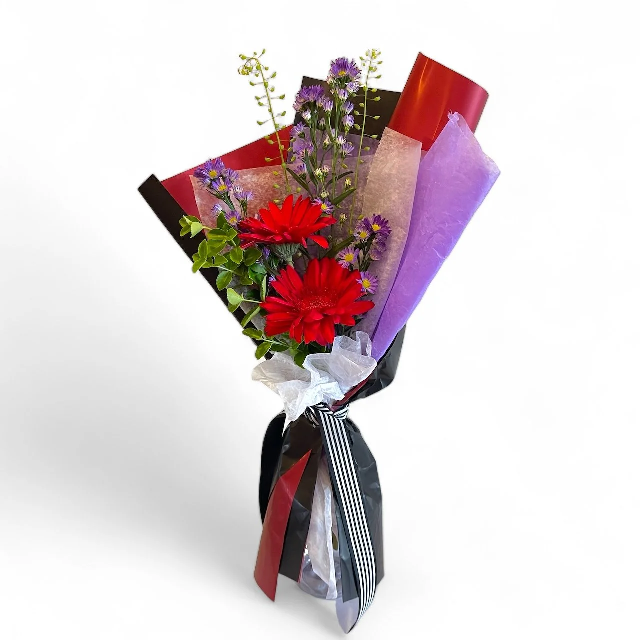 Small bouquet of flowers wrapped in festive paper and tied with a ribbon