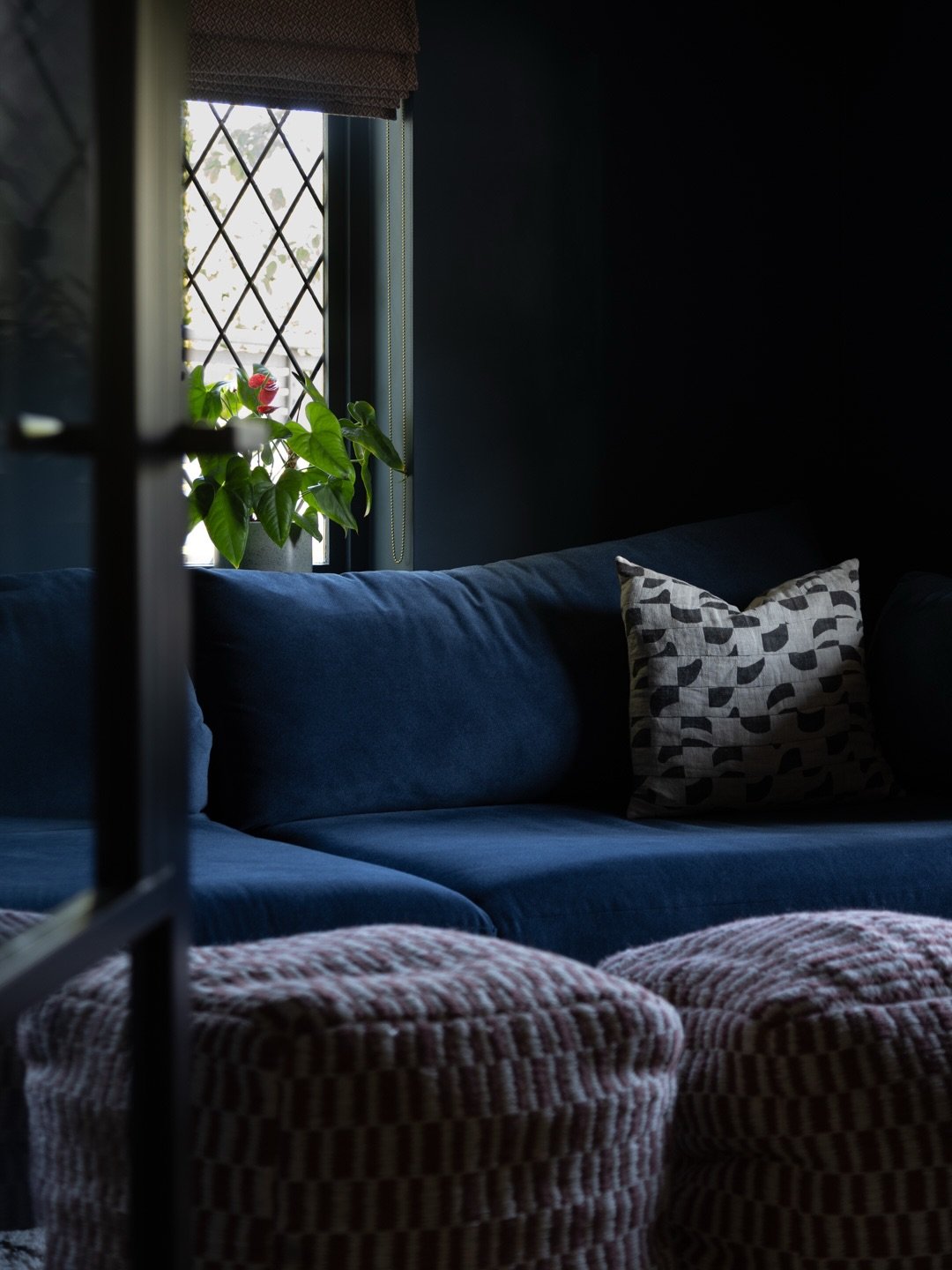 Excited to share this very moody and cosy little family snug 🖤

This room doesn't get lots of natural light so we leaned into it, colour drenching the walls in dark blue and then choosing a sofa in almost the exact same shade. We broke it up with a 