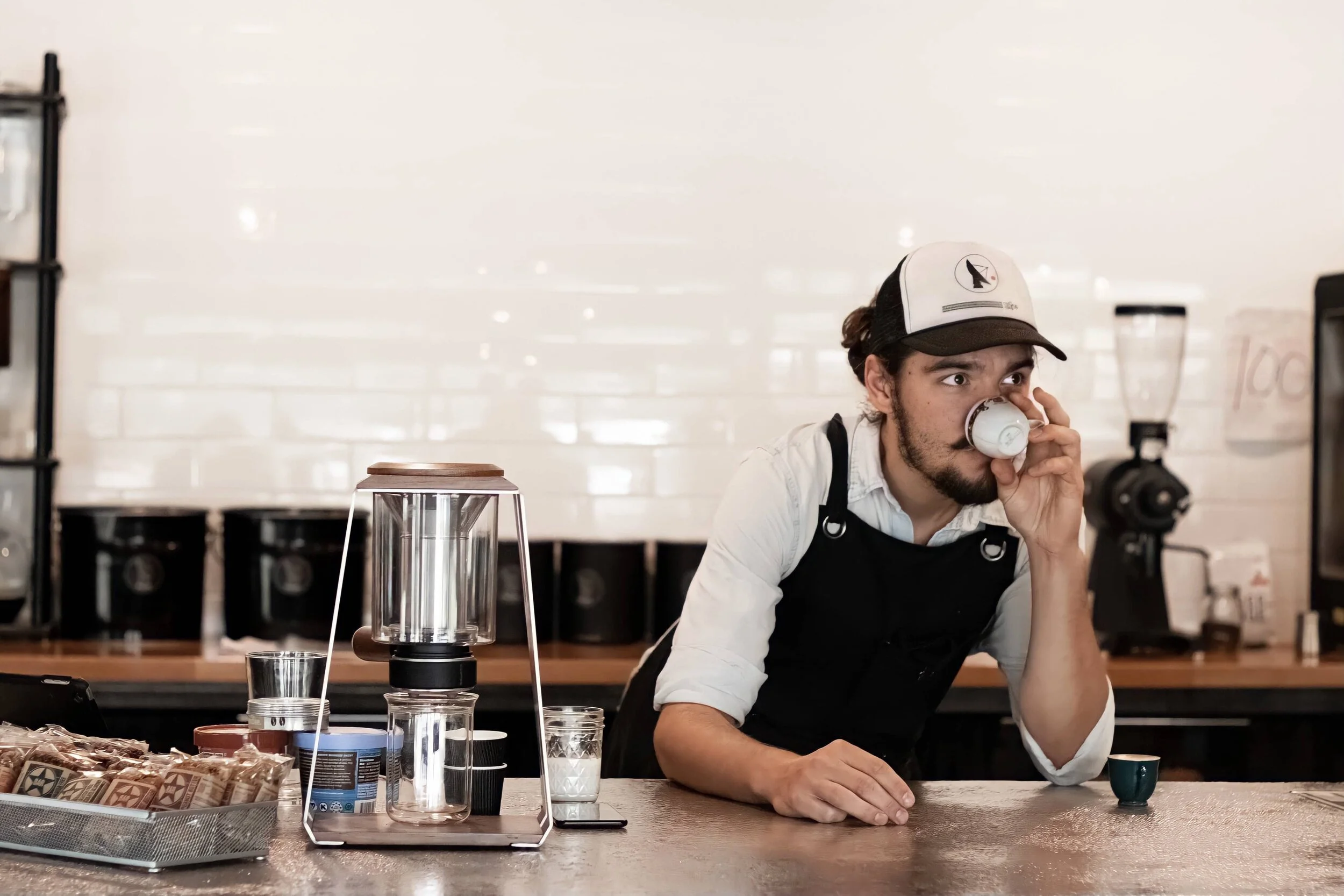 Refuge Coffee Barista in Fairhope Alabama drinking a cup of coffee