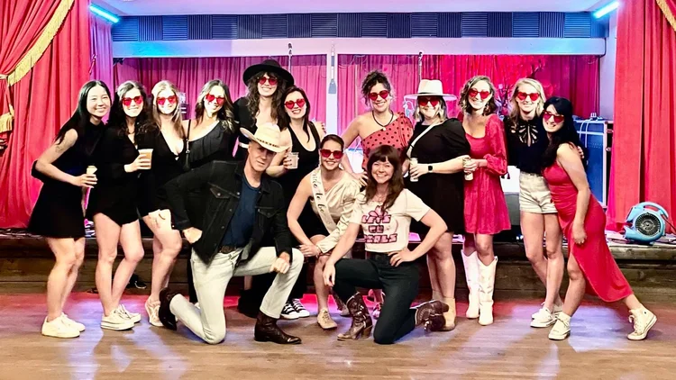 A bachelorette crew in matching outfits at an Austin line dance lesson