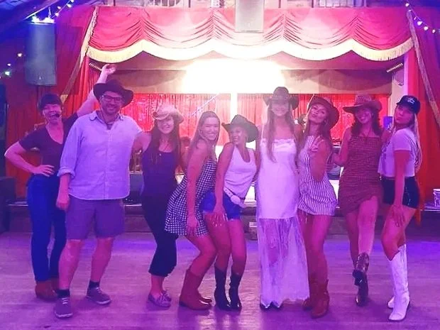Bachelorette party dancing under pink stage lights at Sagebrush in Austin