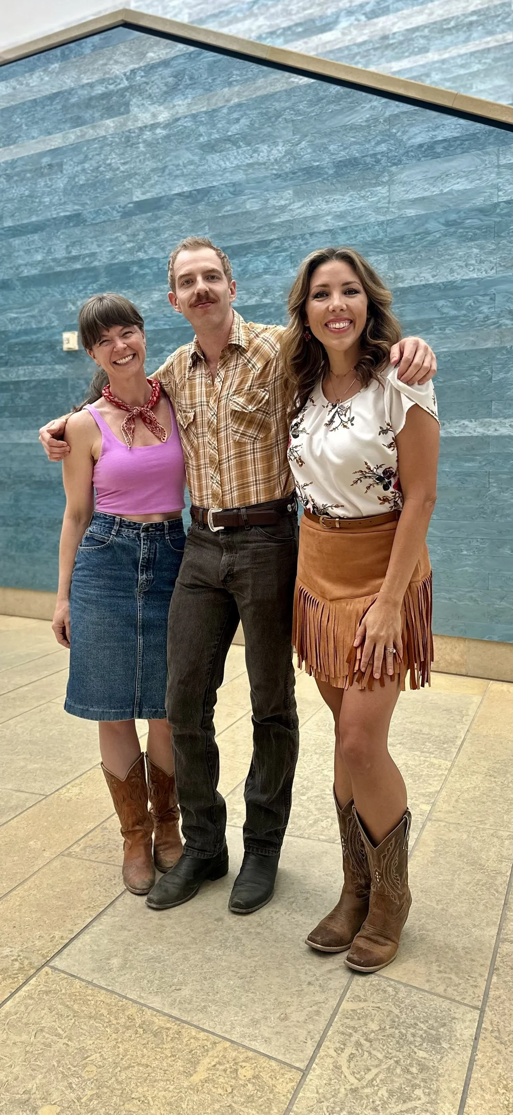 Vanessa Vaught and Dalton Albus of Double or Nothing Two-Step with CBS Austin anchor Allison Miller inside the Blanton Museum