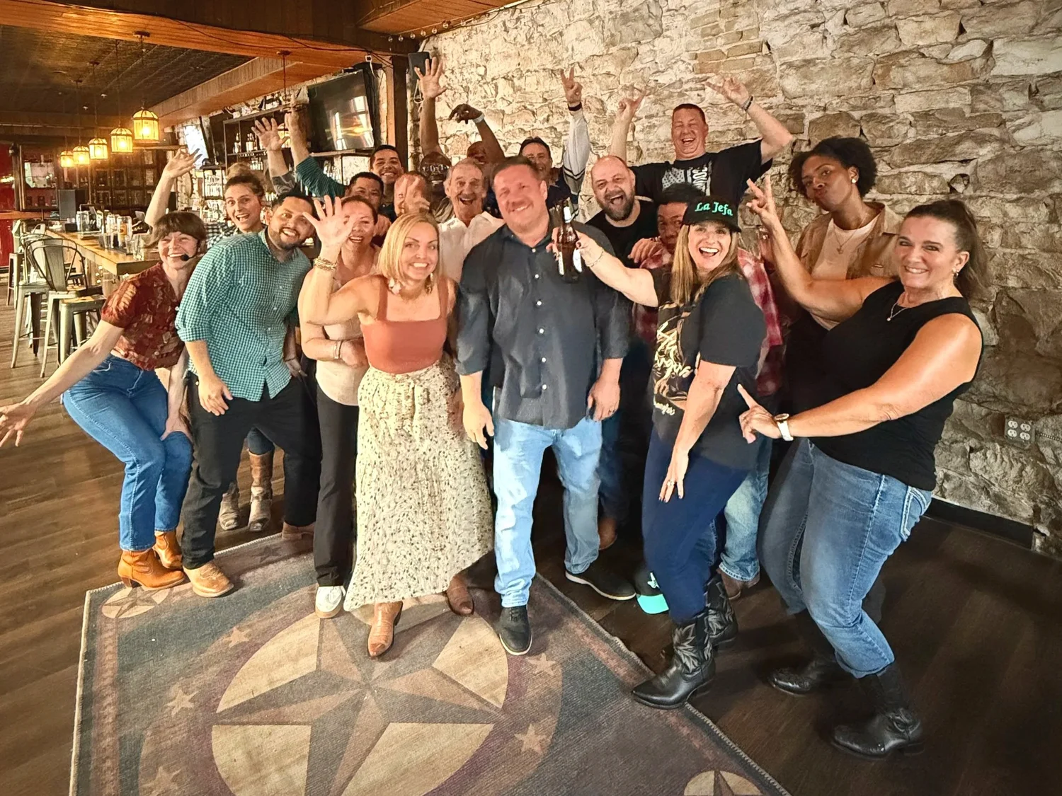 A group cheering together on the dance floor after a Double or Nothing Two-Step lesson at an Austin event