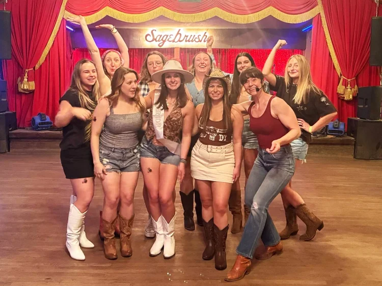 A bachelorette party on stage after an Austin honky-tonk line dance lesson