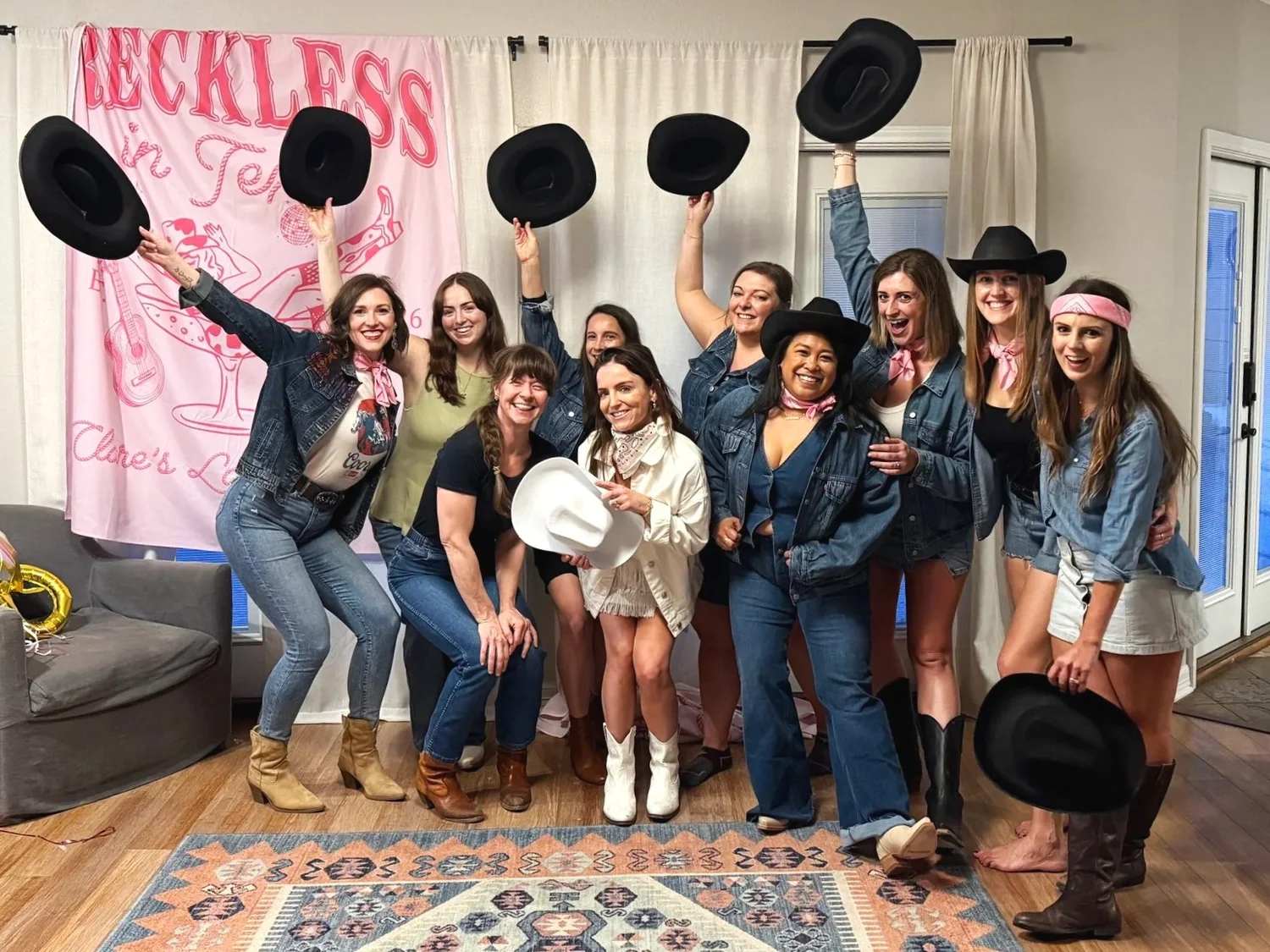 An Austin bachelorette party throwing their cowboy hats in the air after a line dance lesson