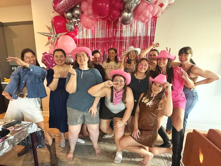 A bachelorette party with a balloon backdrop at an Austin Airbnb line dance lesson