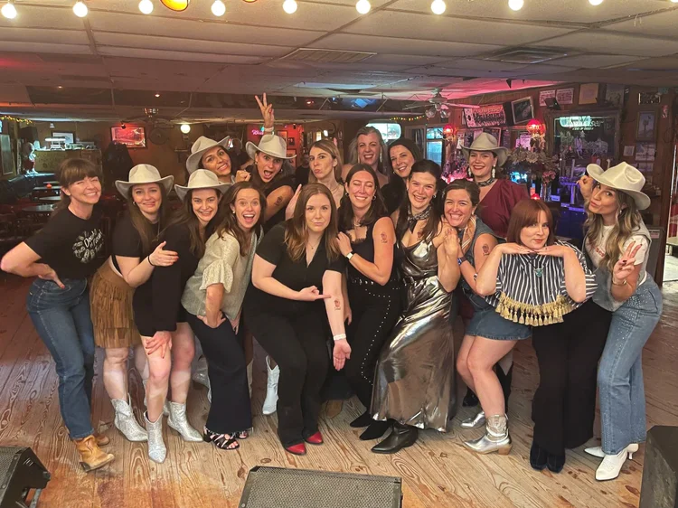 An Austin bachelorette group in cowboy hats at a Double or Nothing line dance lesson