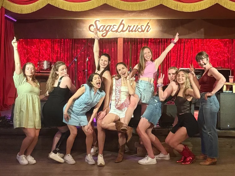 Bachelorette group in denim posing after a line dance lesson at Sagebrush