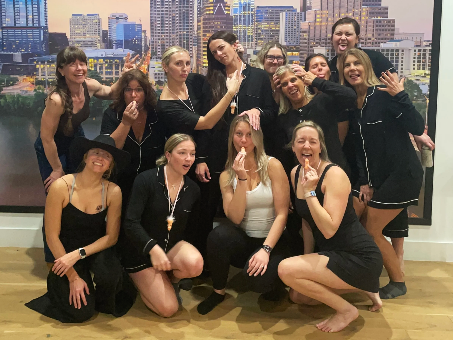 An Austin bachelorette party celebrating outdoors with the downtown skyline behind them