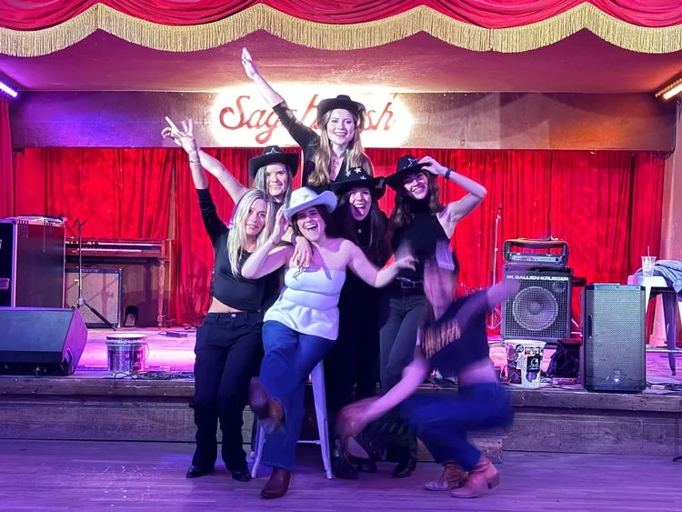 A bachelorette party on stage after an Austin honky-tonk line dance lesson