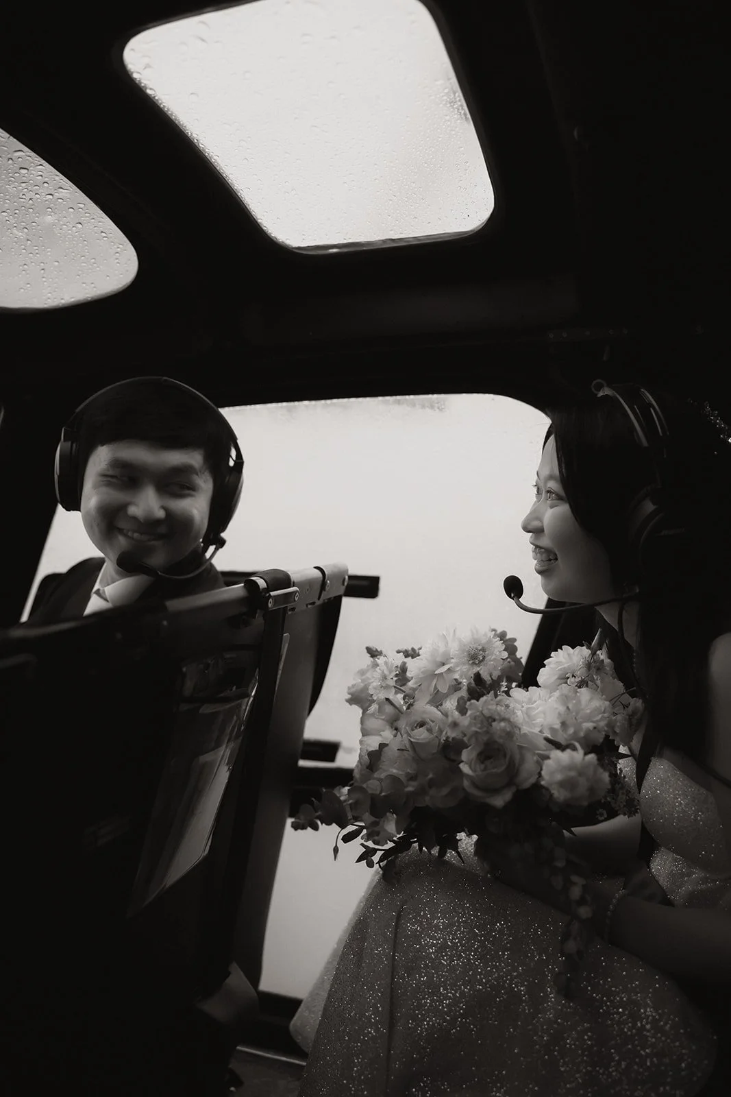 Bride and groom in helicopter en route to Douglas Island elopement in BC.