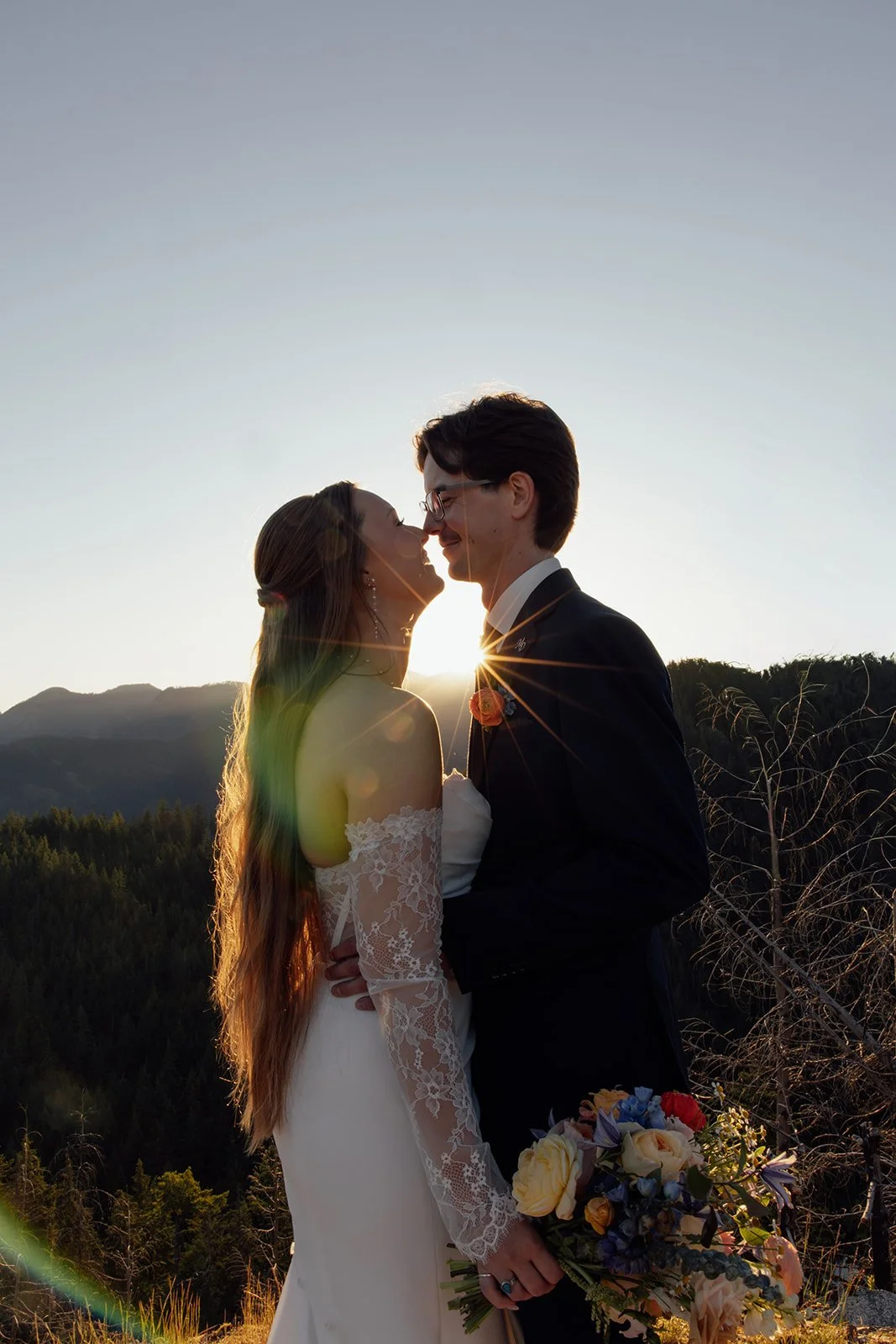 A couple during their sunrise elopement on a mountaintop in Mission, BC