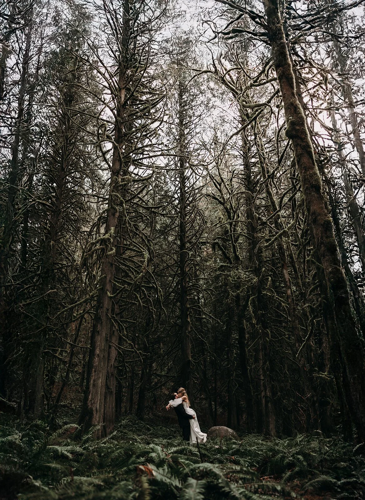 Bride and groom in a forest during their Canadian elopement..