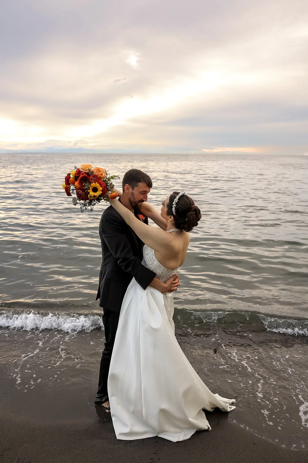 A bride and groom embracing at Wreck Beach after they eloped