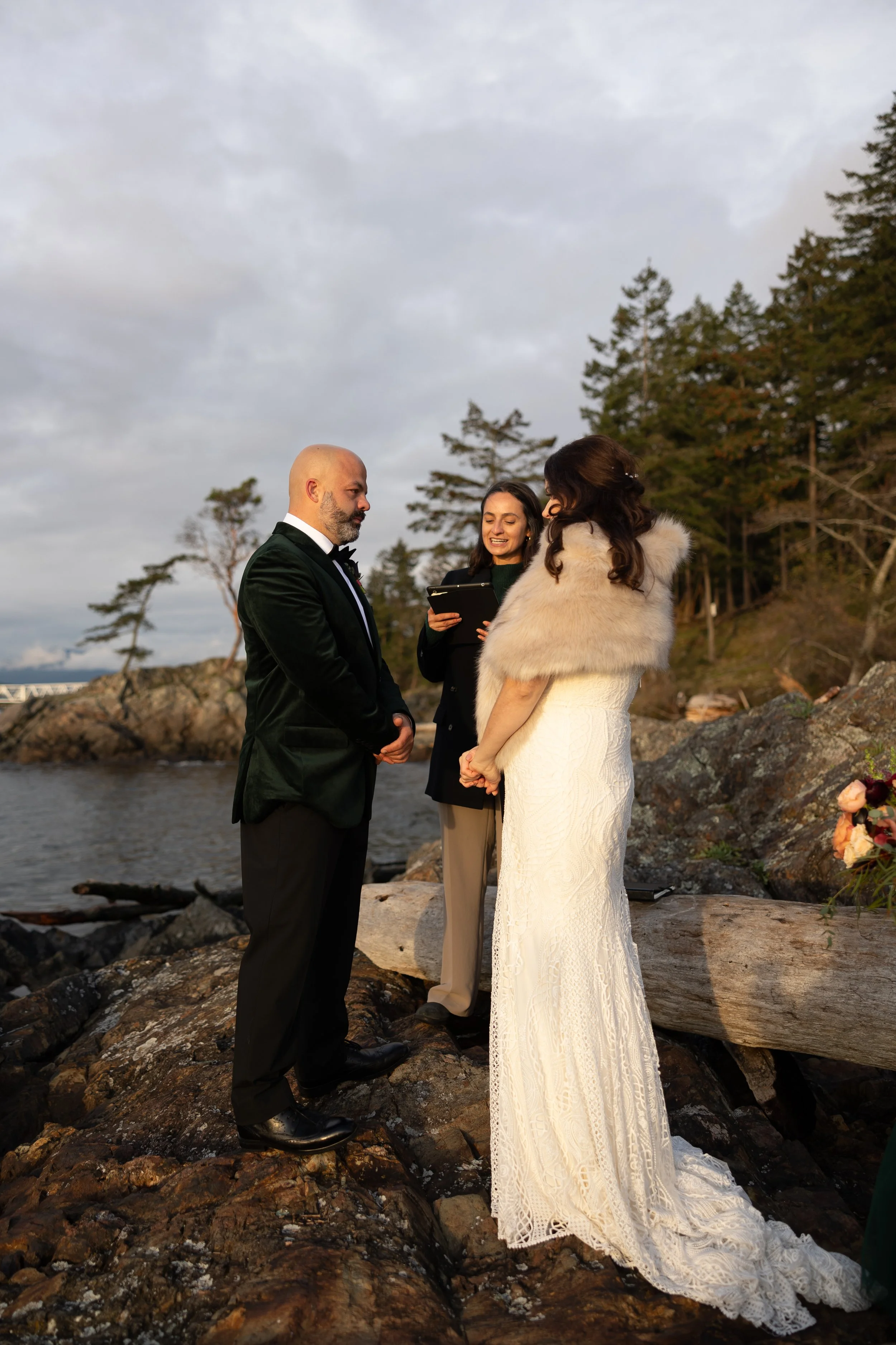 A couple eloping with the officiant in the background.