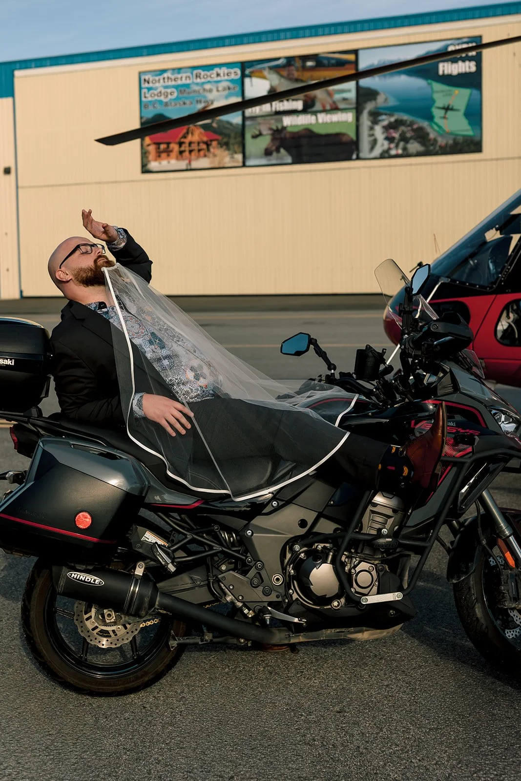 Groom on motor bike, wearing a veil