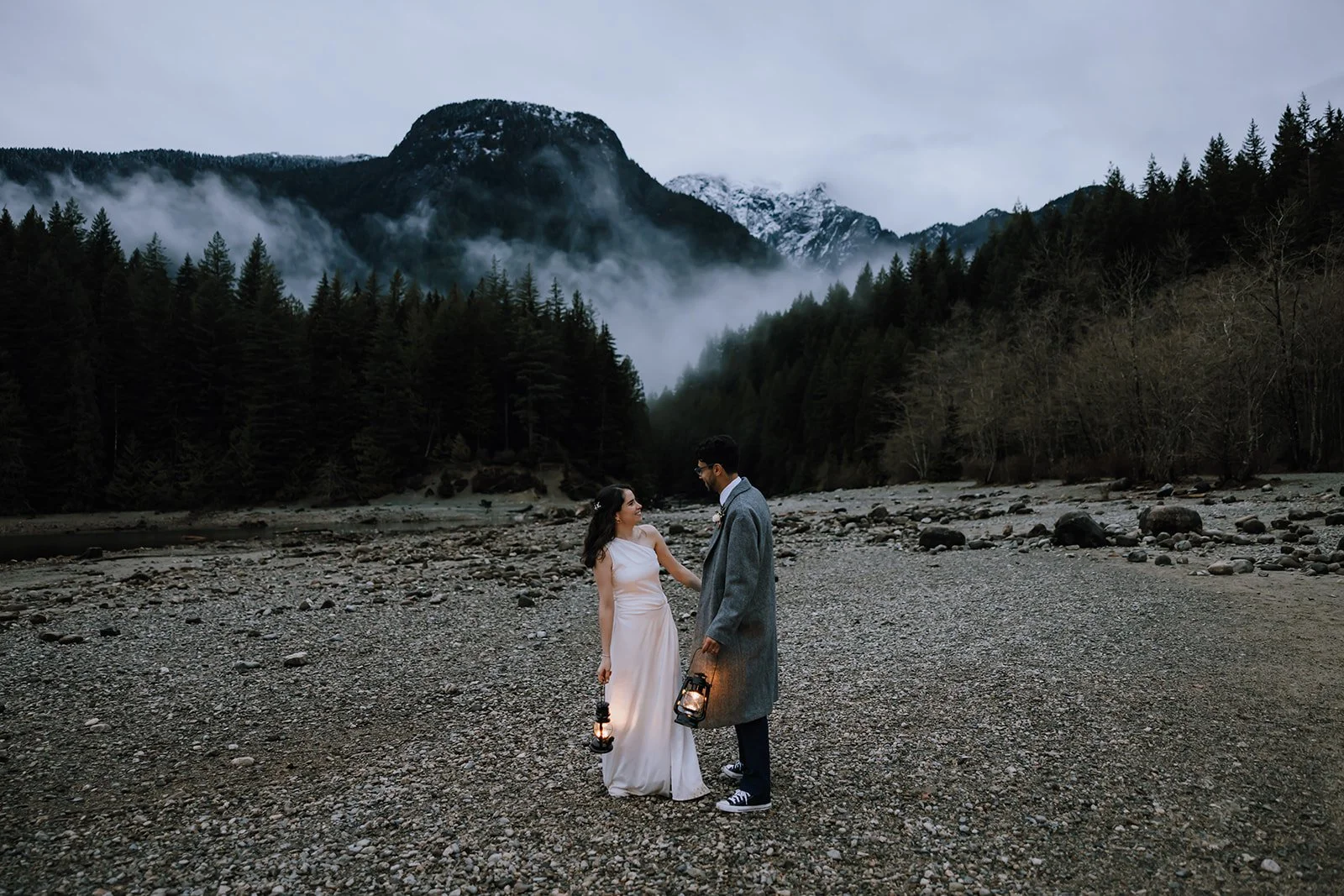 A couple eloping in Golden Ears Provincial Park, holding lanterns in the fog