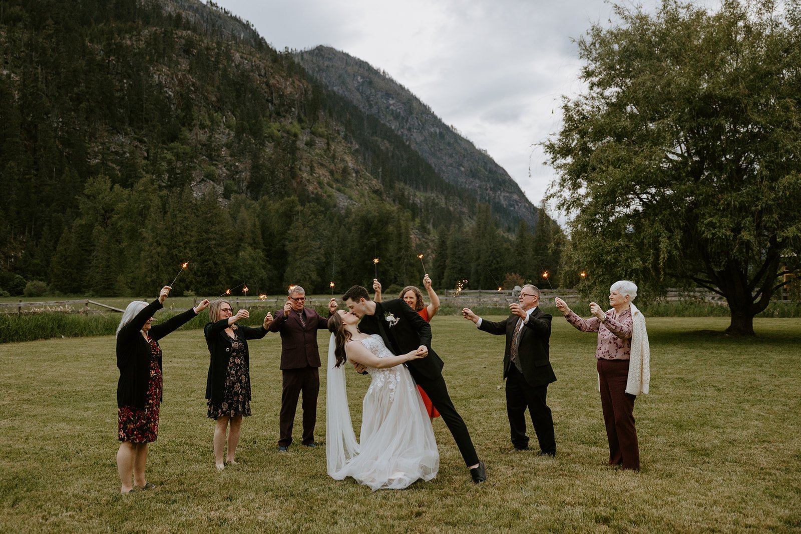 A newly wed couple surrounded by family, celebrating their elopement.