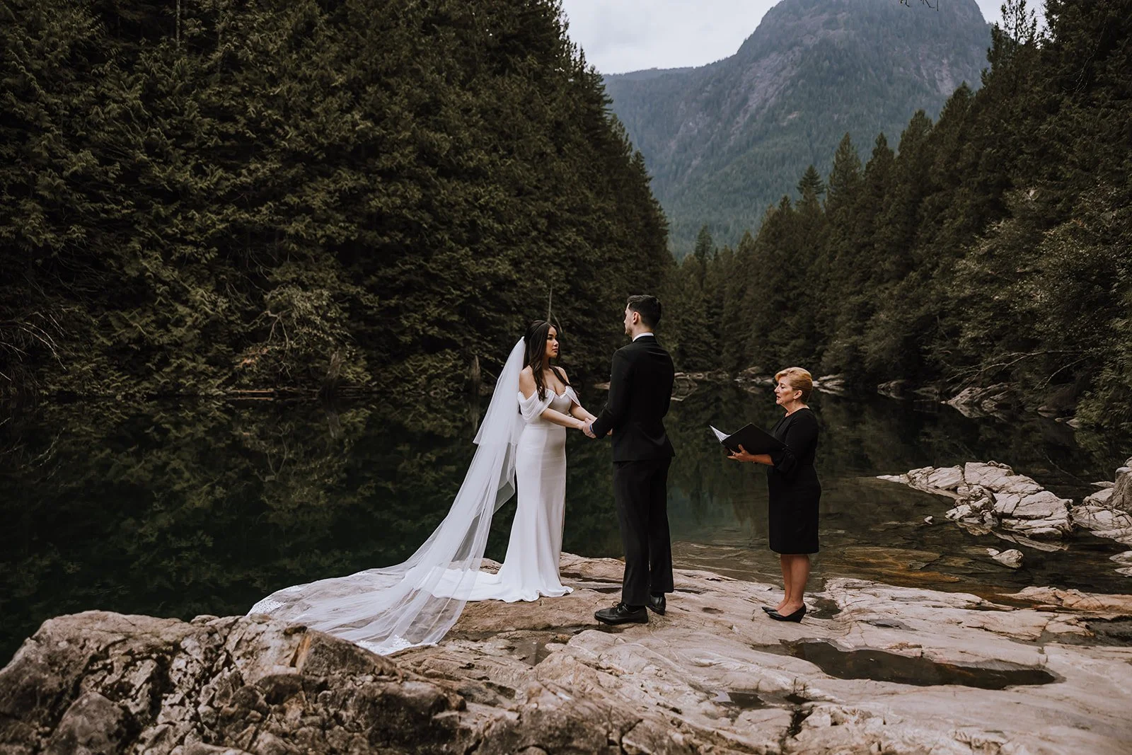 A bride and groom eloping with their officiant