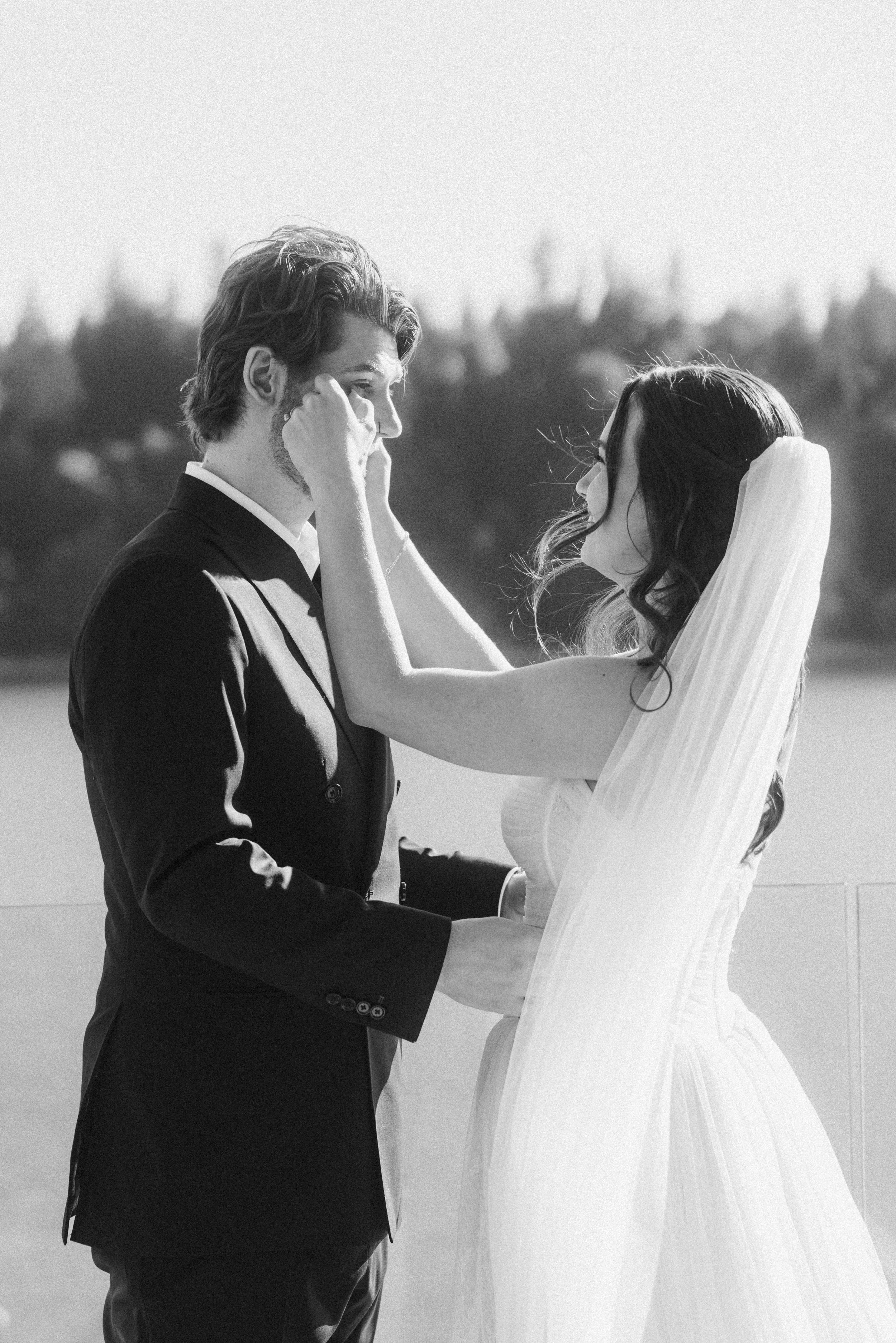 Bride and groom holding each other with nature in the background