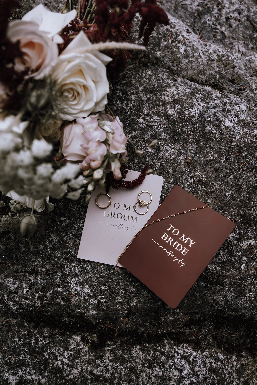 Romantic flat lay of elopement keepsakes telling the love story of a bride and groom in a nature-inspired setting