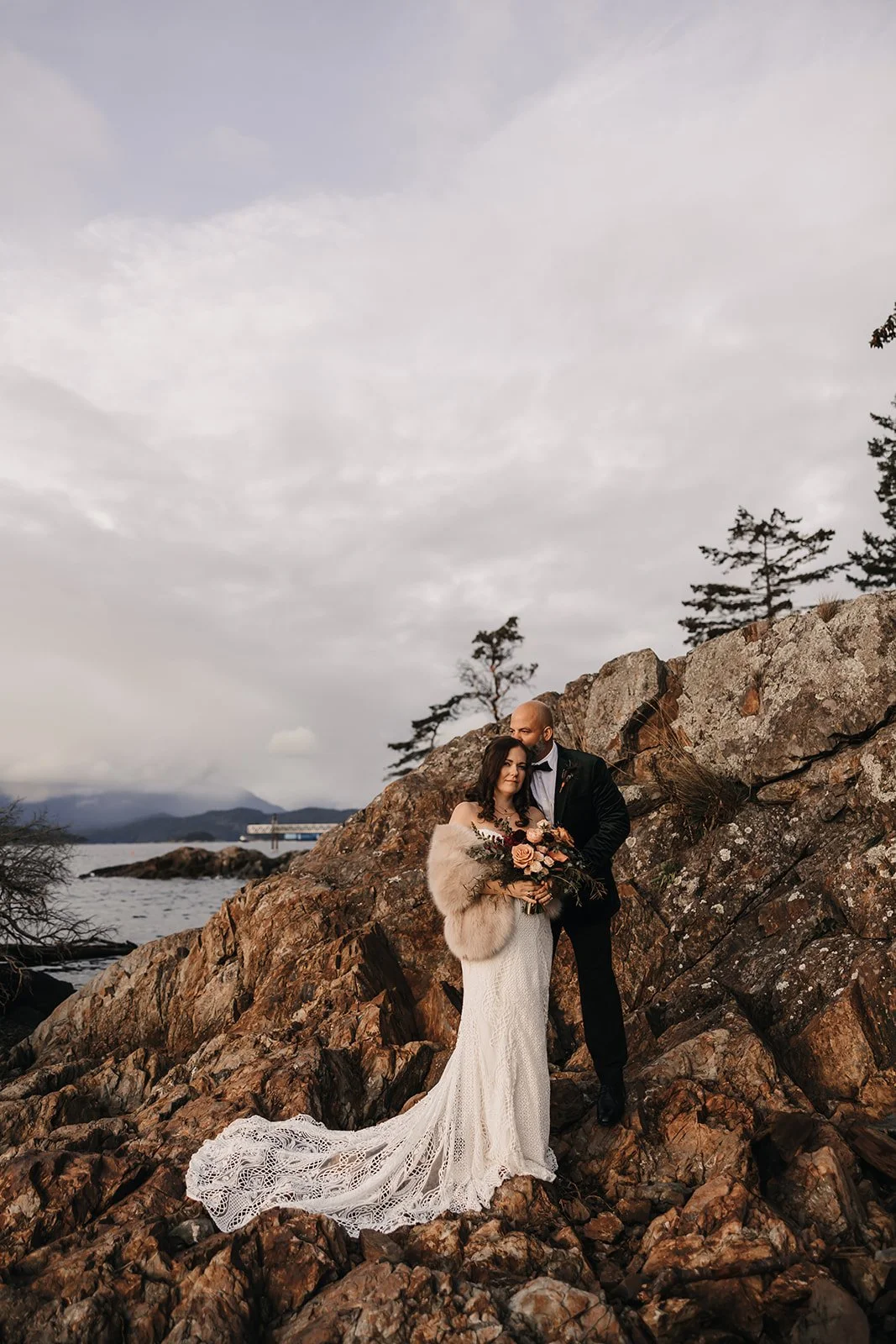 Romantic BC coastal elopement – groom kisses bride in Vancouver wedding.