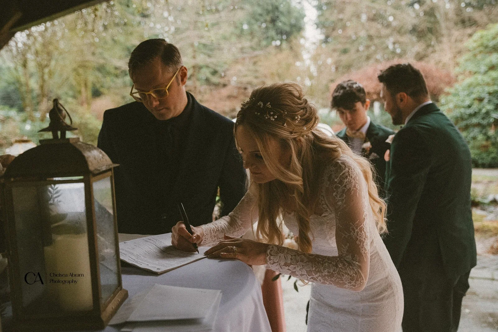 A bride signing paperwork during her BC elopement.