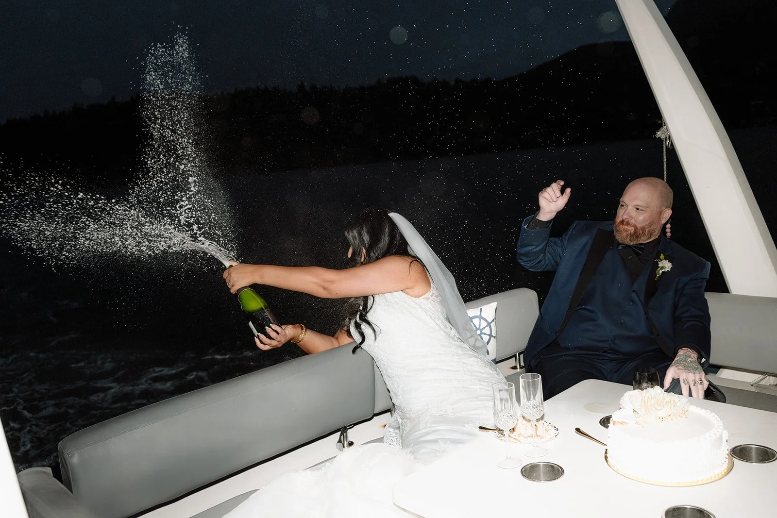 A bride and groom toast during their yacht elopement