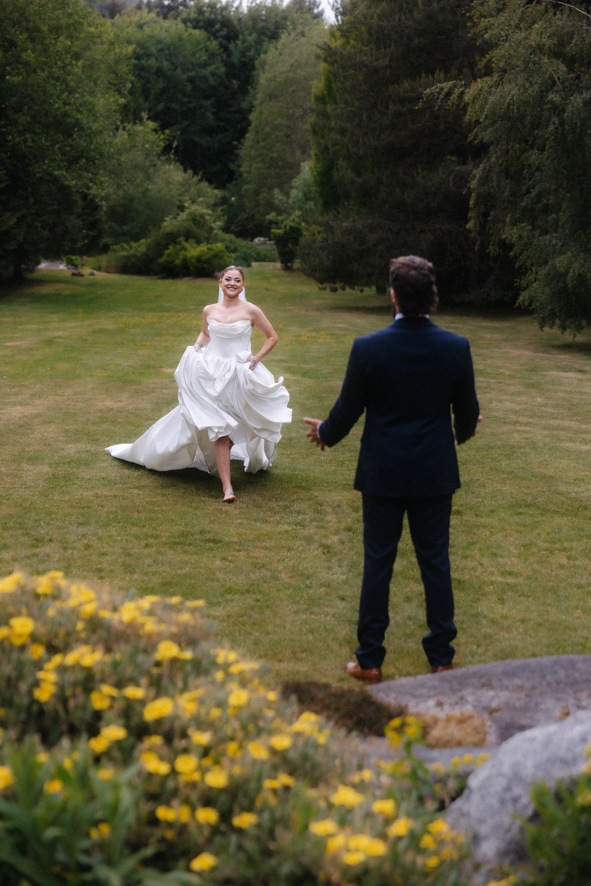 A bride, running to meet her groom during their outdoor wedding
