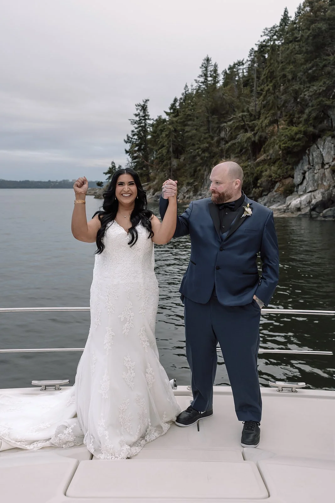 A bride and groom celebrate their elopement on a yacht near Granville Island
