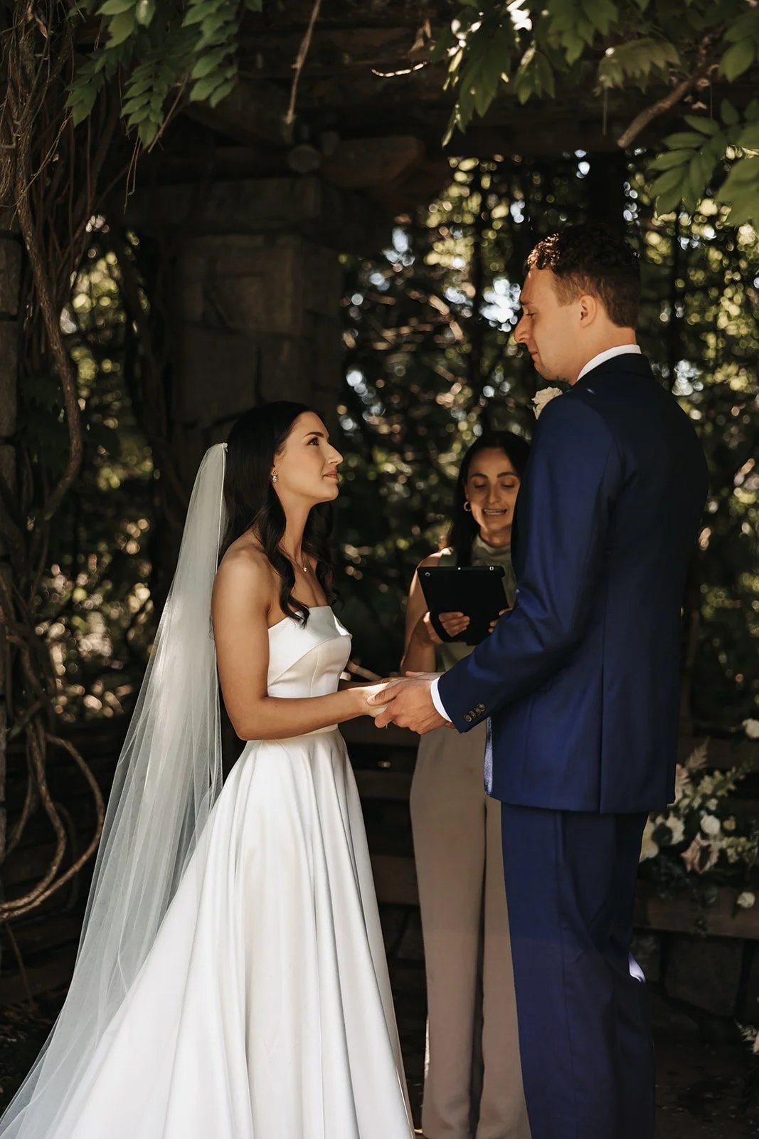 A couple eloping, listening to their officiant