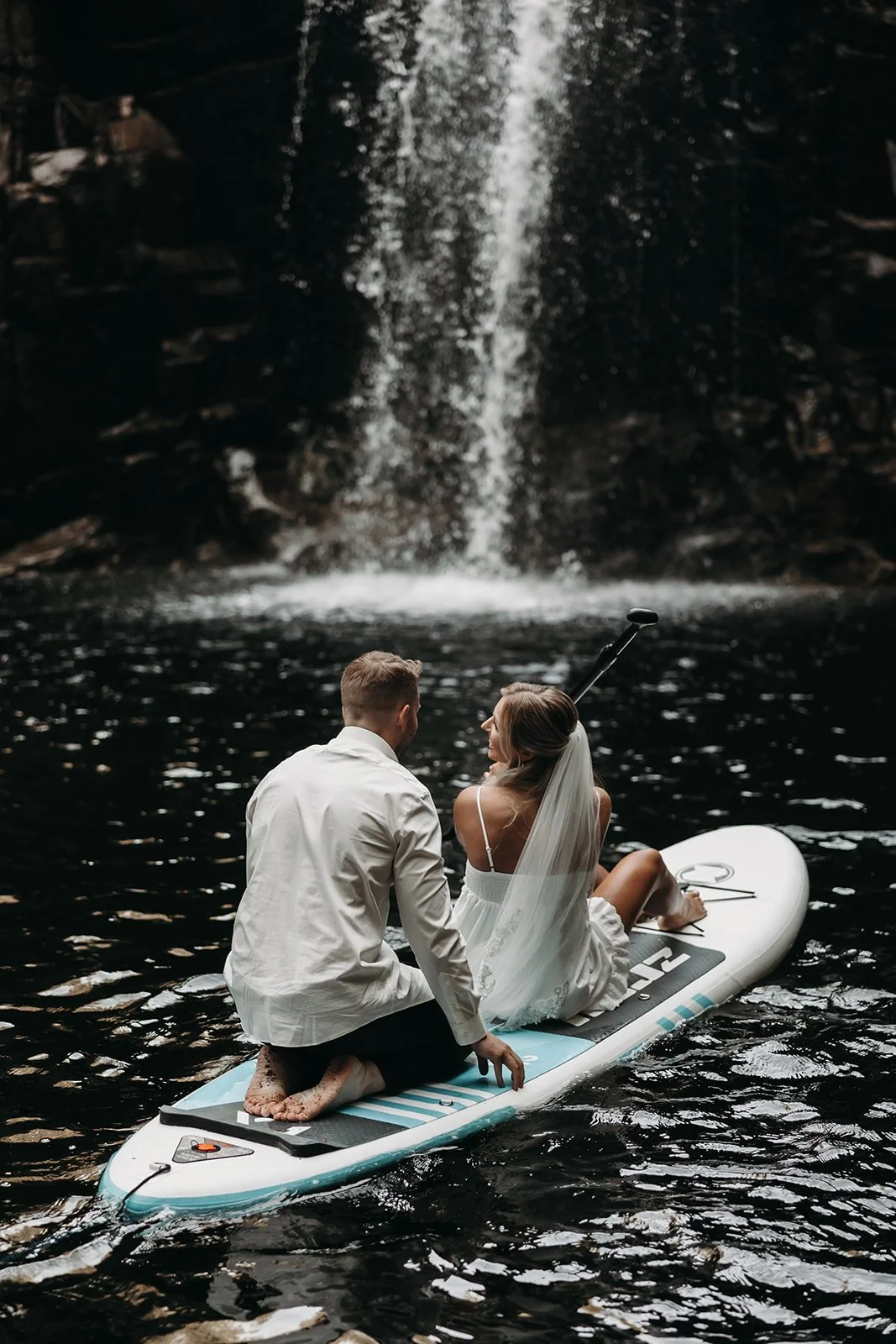 Romantic BC adventure elopement with couple riding waves