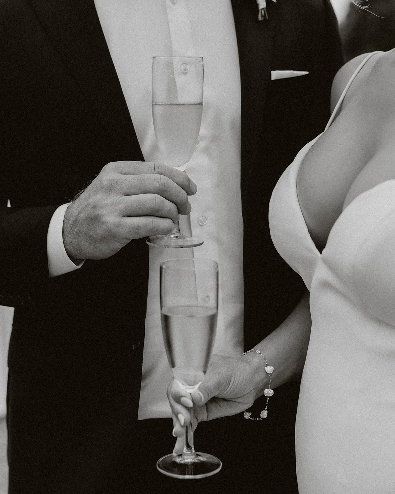 A bride and groom holding champagne glasses