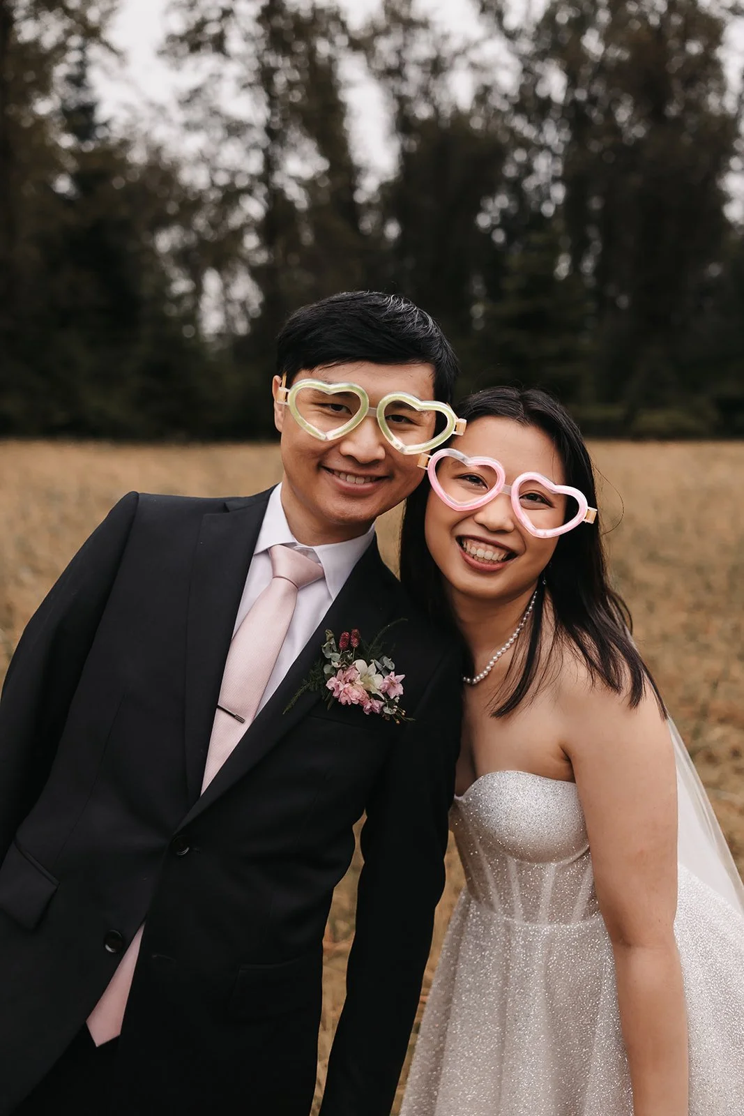 Bride and groom in heart glasses at Douglas Island helicopter elopement BC.
