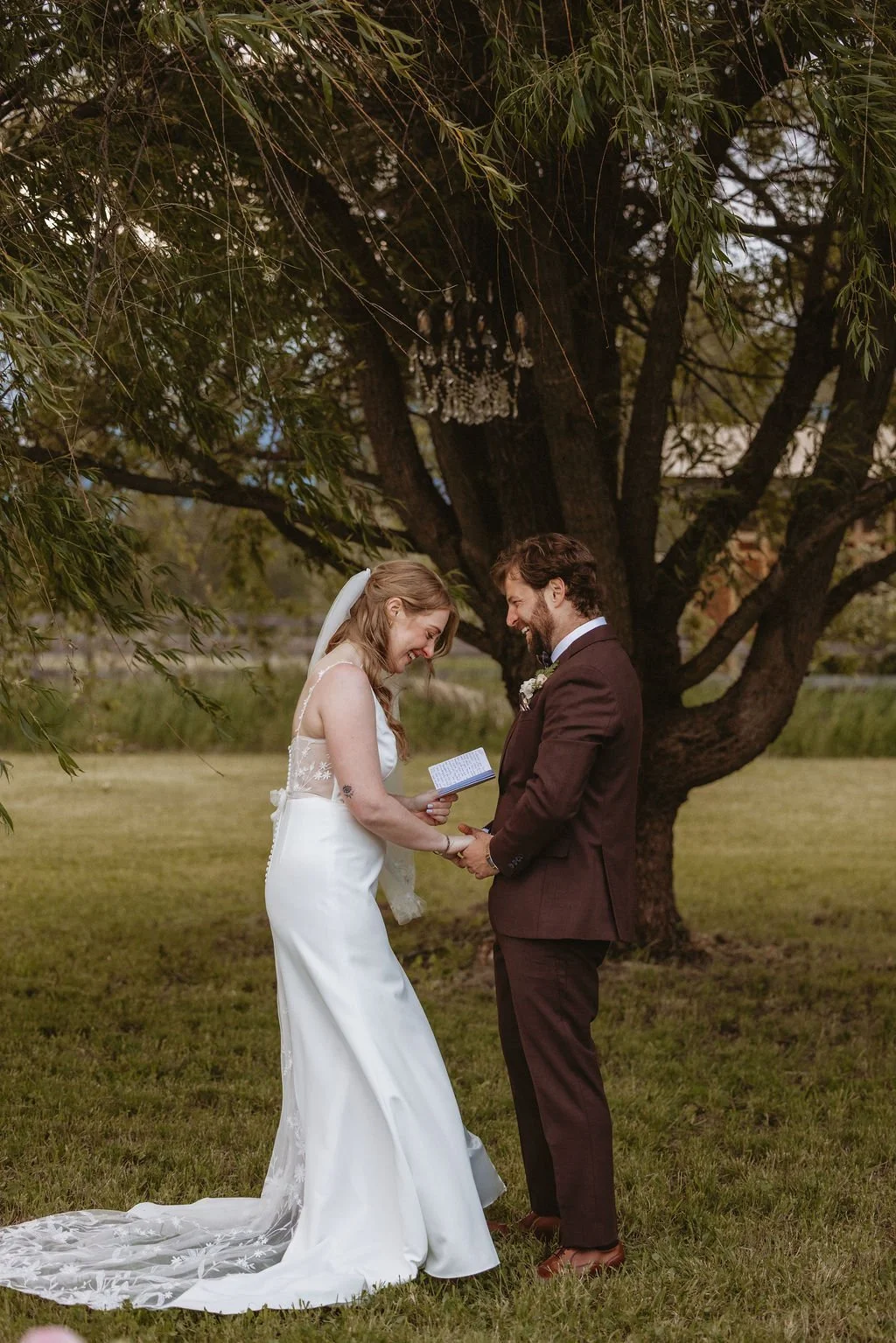 A couple laughing as they exchange vows
