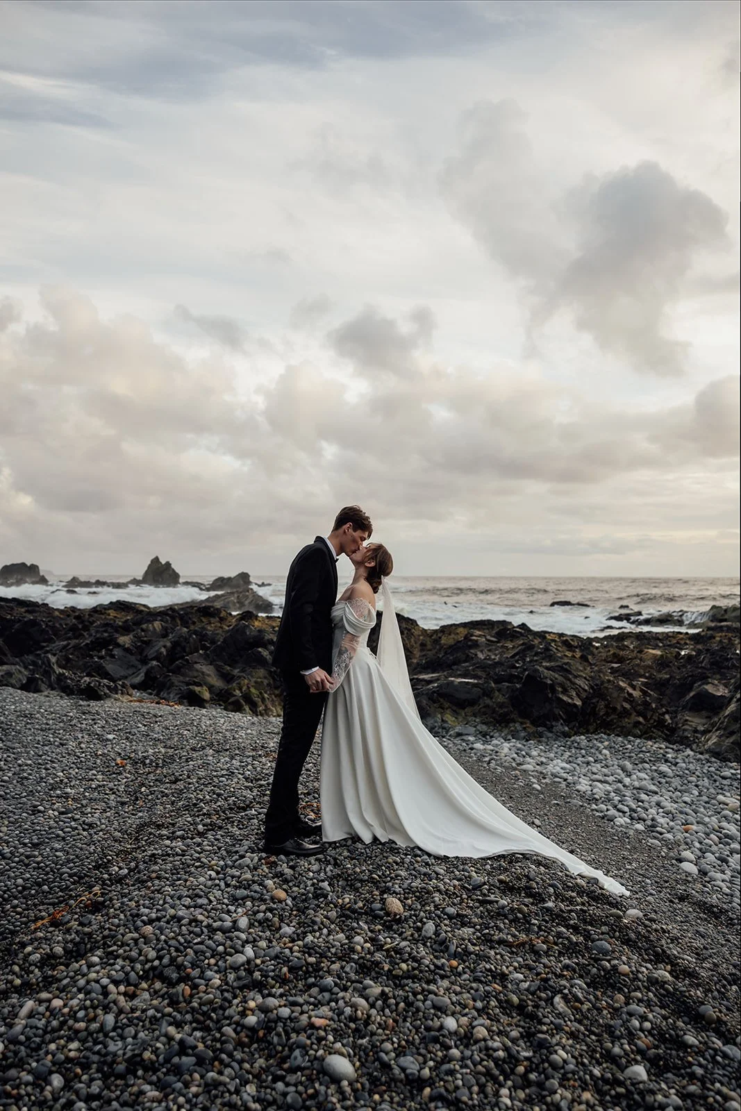 A bride and groom kissing in Tofino