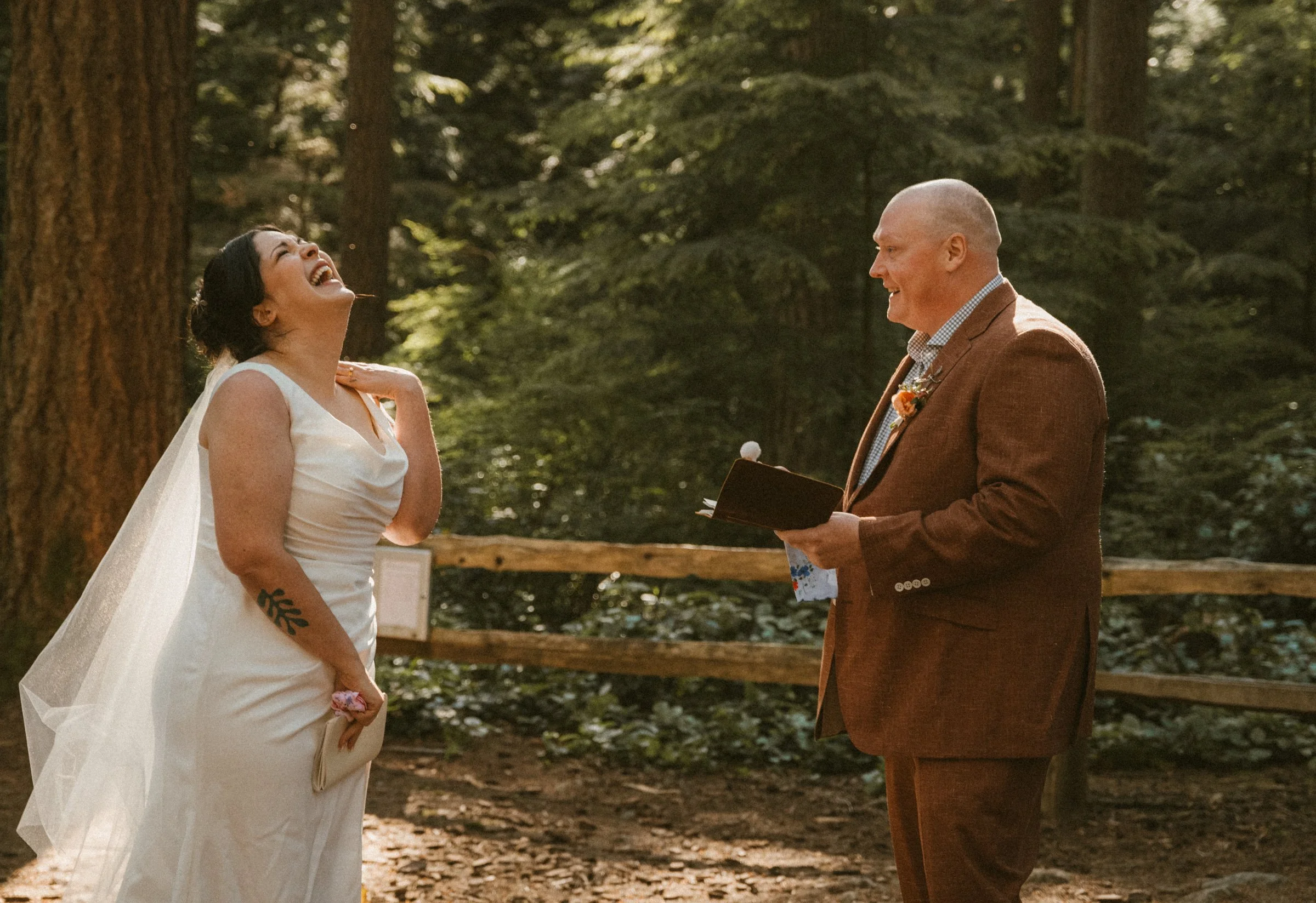 A couple laughing while they exchange heart-felt vows at their elopement