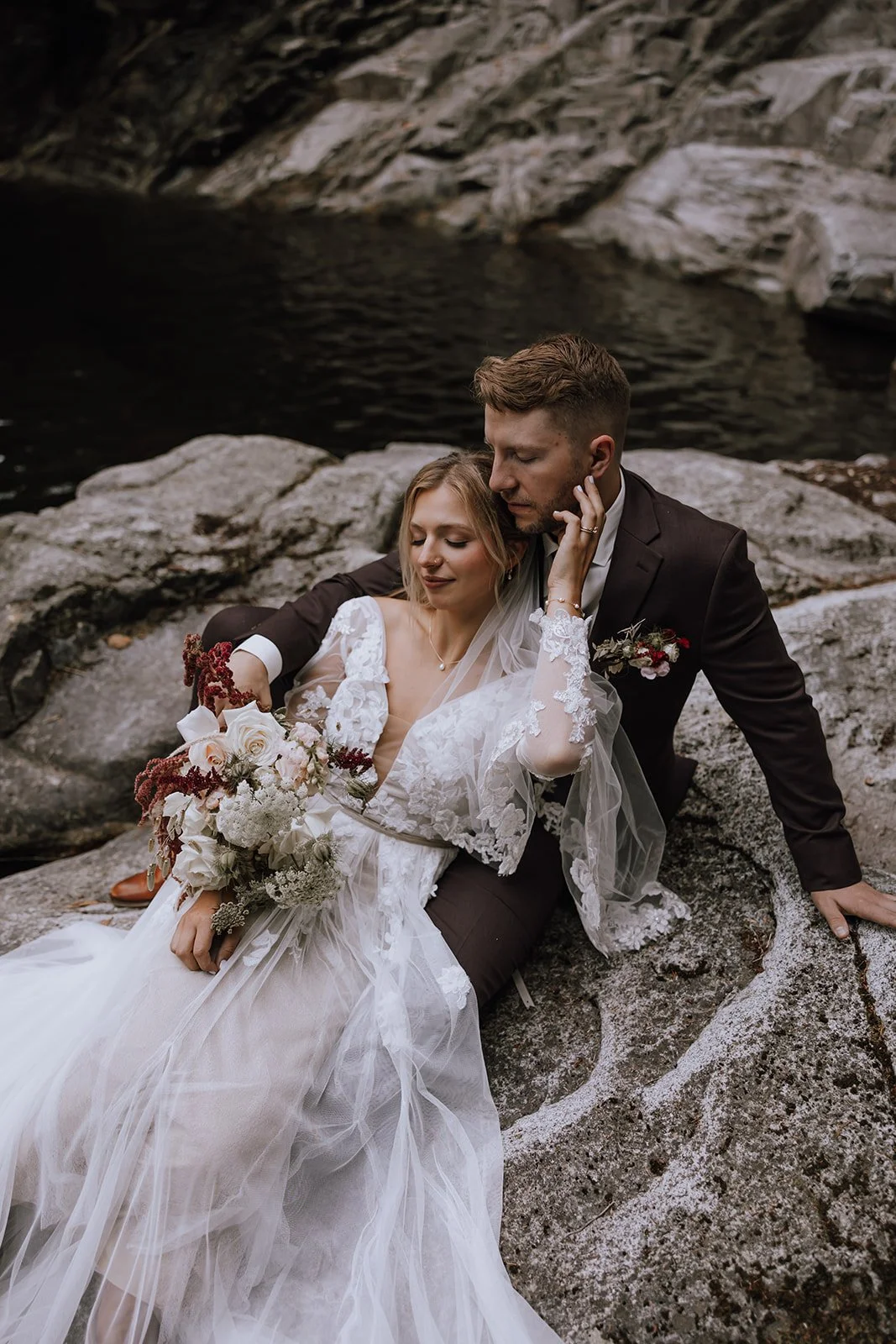 Couple embracing on the shore of Powell River during their intimate, adventurous elopement