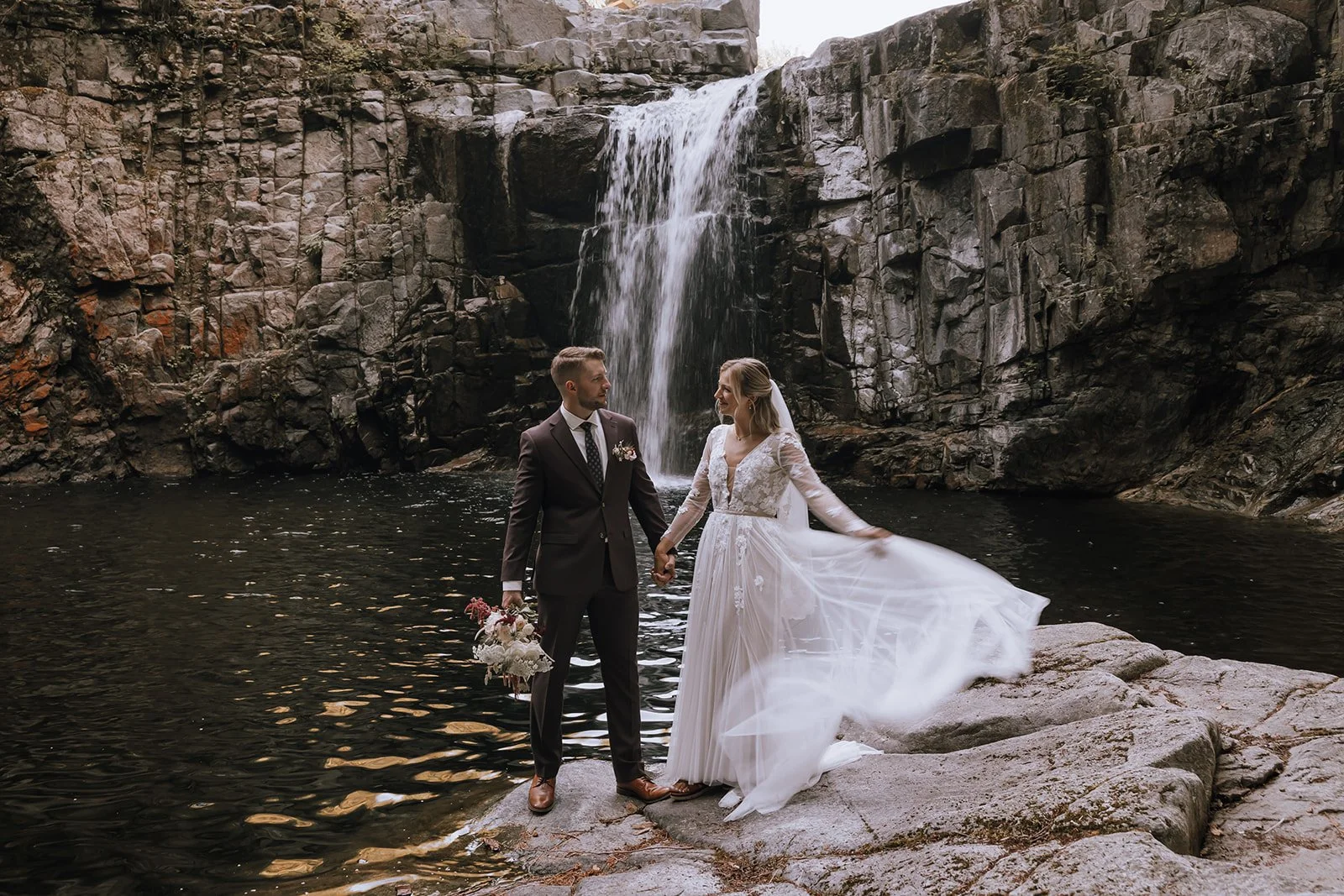 A bride and groom elope while holding hands in Golden Ears Provincial Park