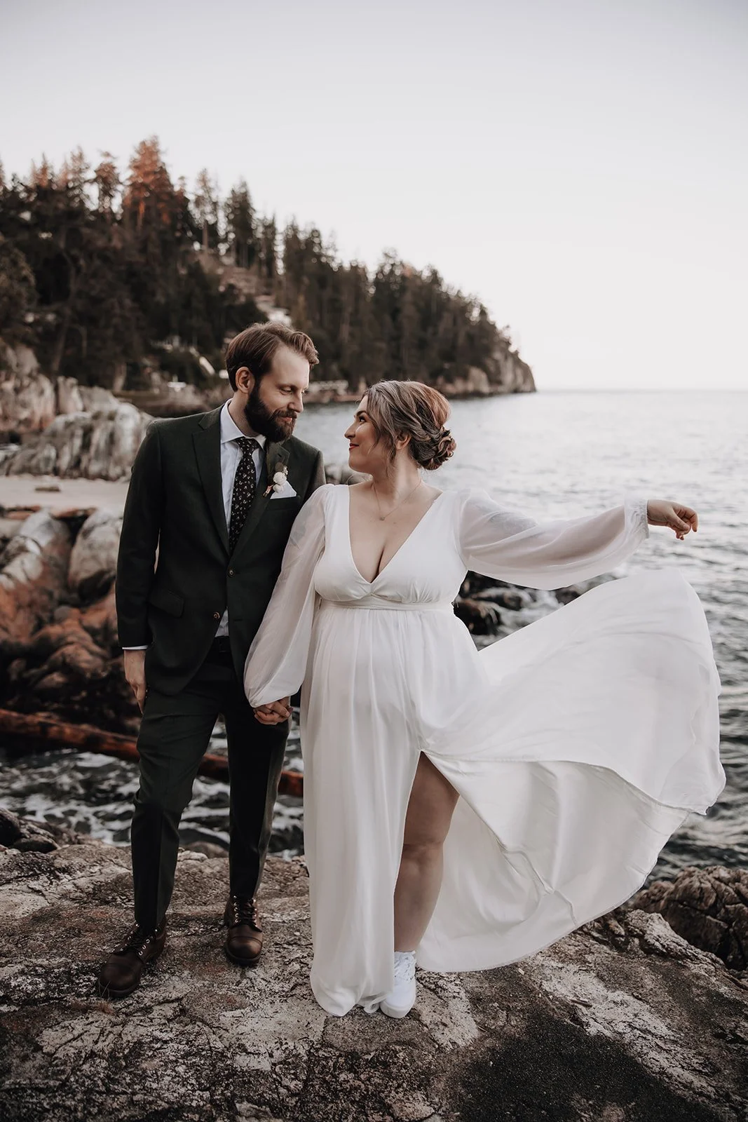 A couple eloping with the BC shoreline in the background