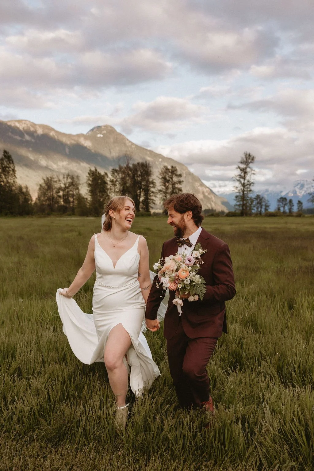 A bride and groom eloping with a mountain backdrop