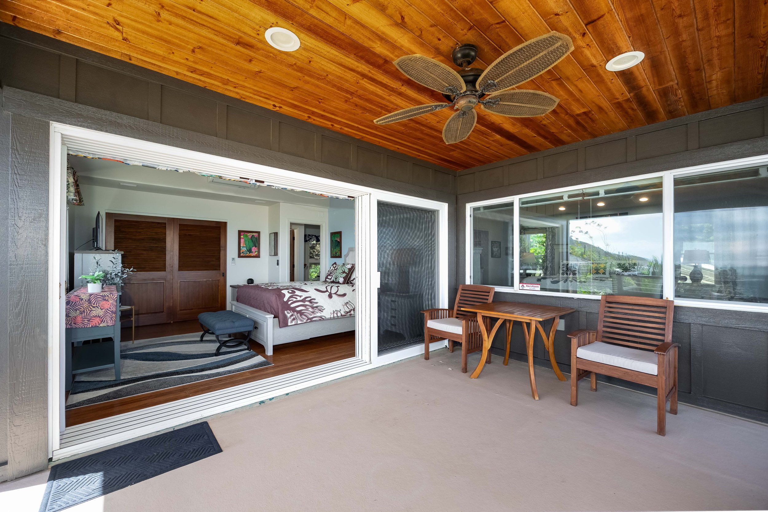 Stacking sliding doors open up to a covered and open wraparound lanai.