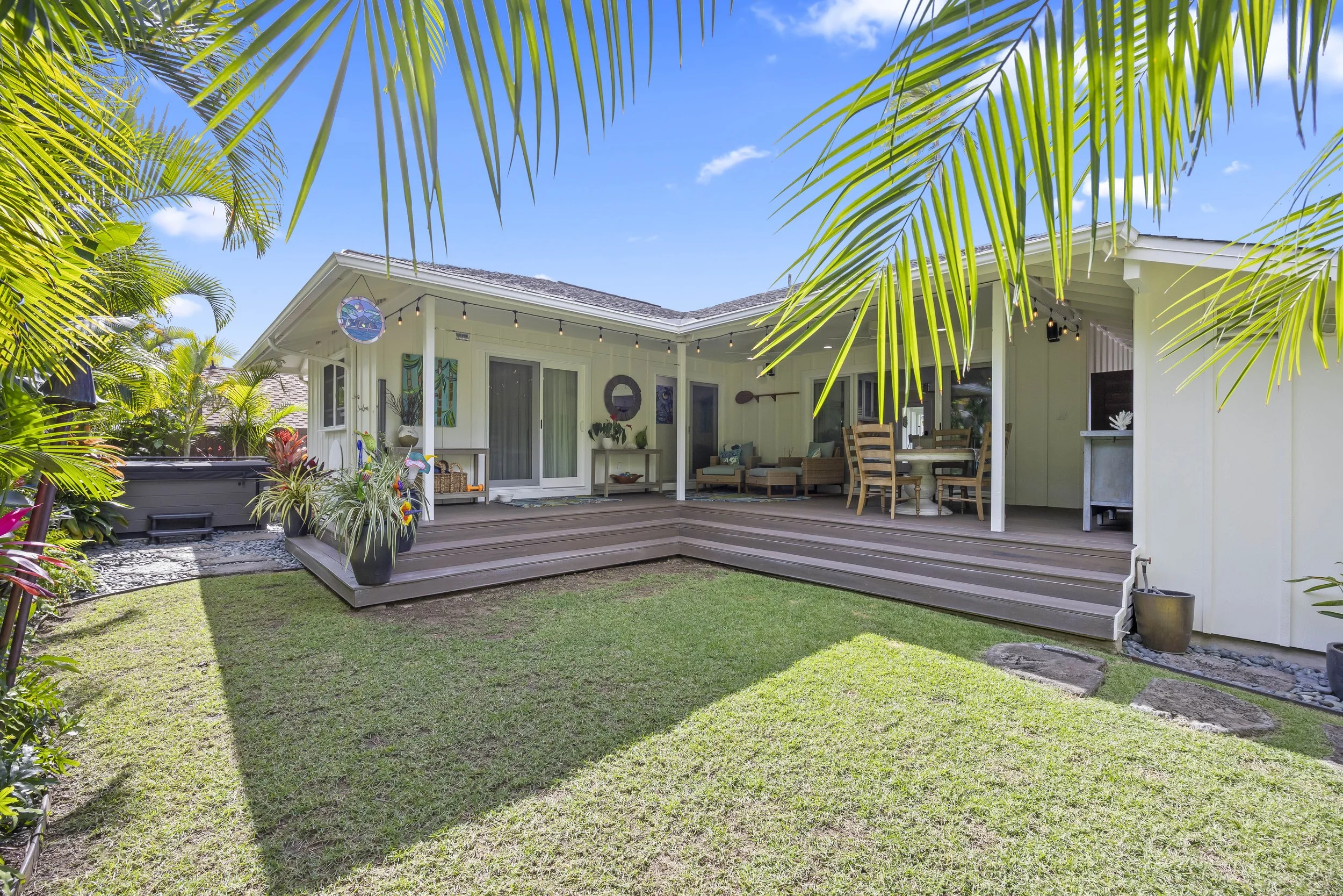 Professionally landscaped back yard with an outdoor shower and a top-quality hot tub.