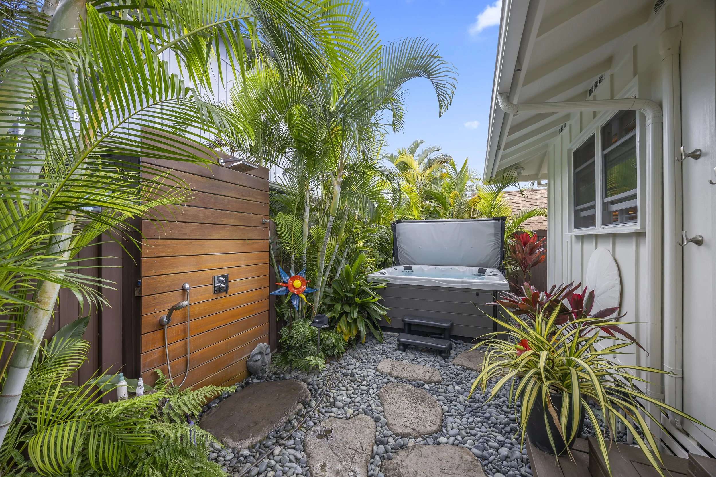 Outdoor shower with retractable privacy screen, and a top-quality hot tub with convenient cover lift